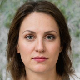 Joyful white young-adult female with medium  brown hair and green eyes