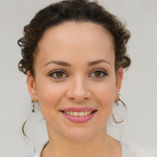 Joyful white young-adult female with medium  brown hair and green eyes