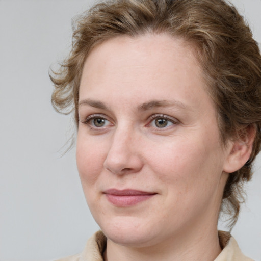 Joyful white adult female with medium  brown hair and blue eyes