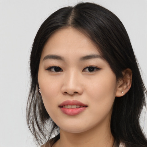 Joyful asian young-adult female with long  black hair and brown eyes