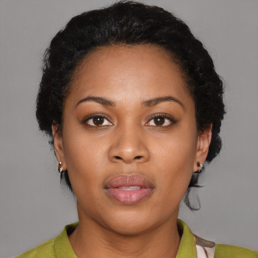 Joyful black young-adult female with short  brown hair and brown eyes