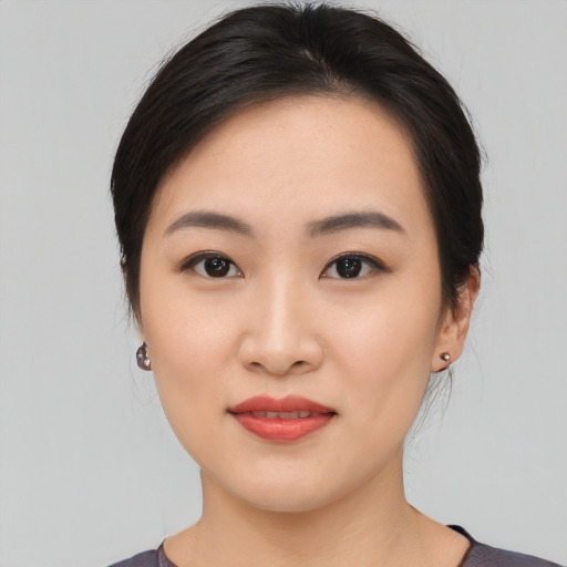 Joyful asian young-adult female with medium  black hair and brown eyes