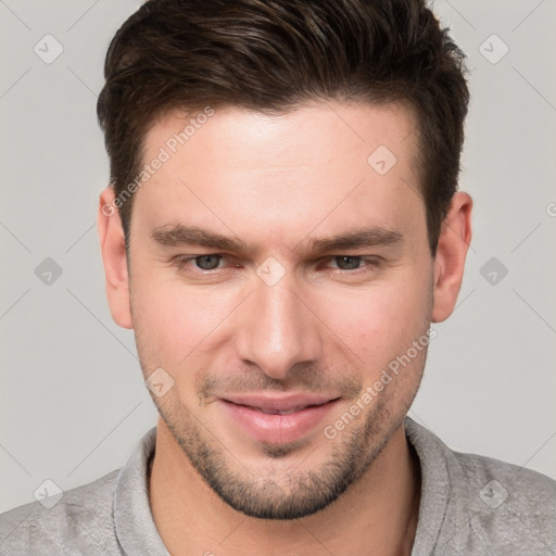 Joyful white young-adult male with short  brown hair and grey eyes