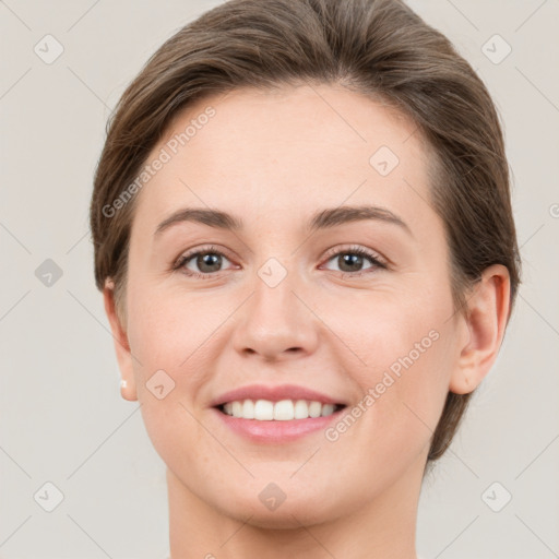 Joyful white young-adult female with short  brown hair and grey eyes