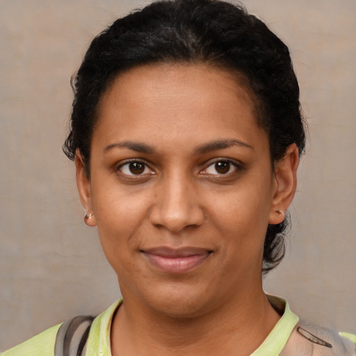 Joyful black young-adult female with short  brown hair and brown eyes