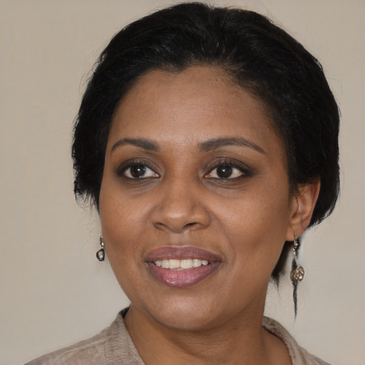 Joyful black adult female with medium  brown hair and brown eyes