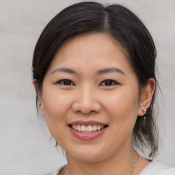 Joyful white adult female with medium  brown hair and brown eyes