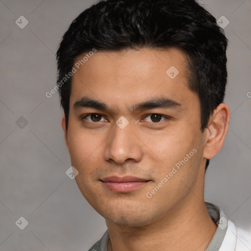 Joyful asian young-adult male with short  black hair and brown eyes