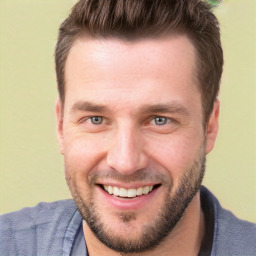 Joyful white young-adult male with short  brown hair and brown eyes