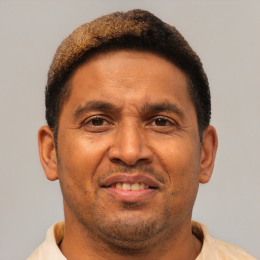 Joyful latino adult male with short  brown hair and brown eyes