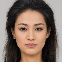 Joyful asian young-adult female with long  brown hair and brown eyes