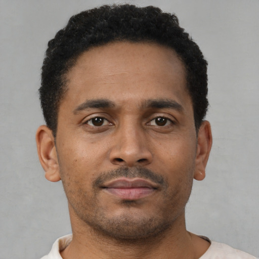 Neutral latino young-adult male with short  brown hair and brown eyes