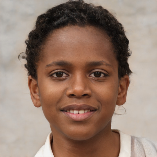 Joyful black child female with short  brown hair and brown eyes