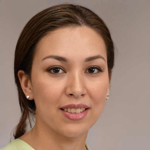 Joyful white young-adult female with medium  brown hair and brown eyes