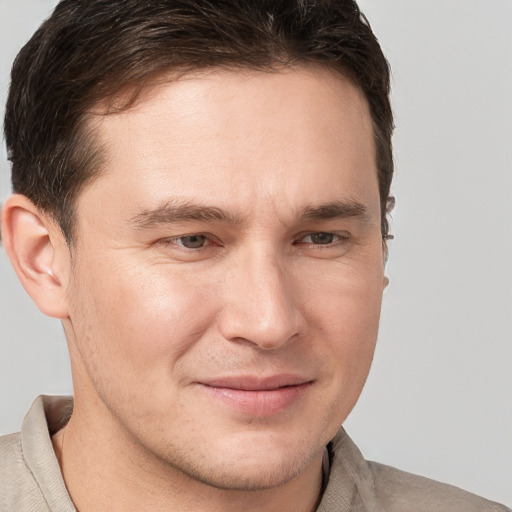 Joyful white young-adult male with short  brown hair and brown eyes