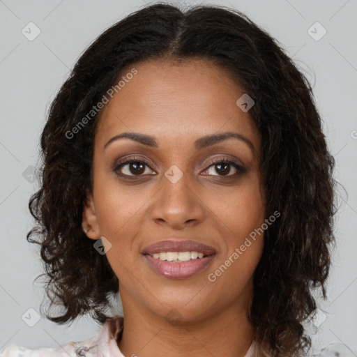 Joyful black young-adult female with long  brown hair and brown eyes