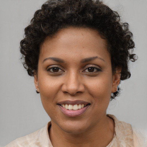 Joyful black young-adult female with short  brown hair and brown eyes