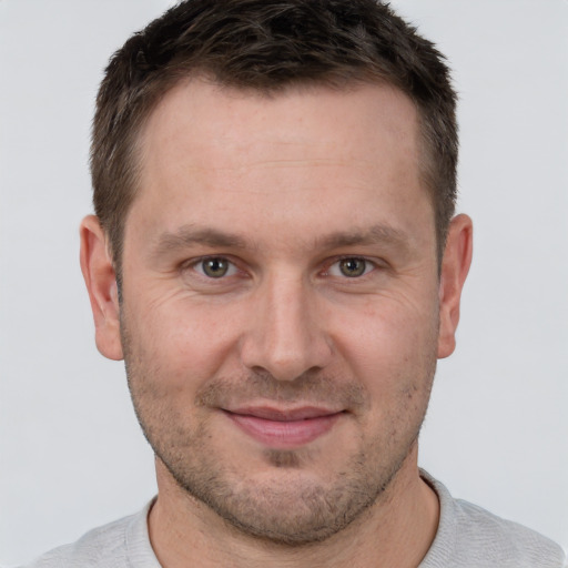 Joyful white adult male with short  brown hair and brown eyes