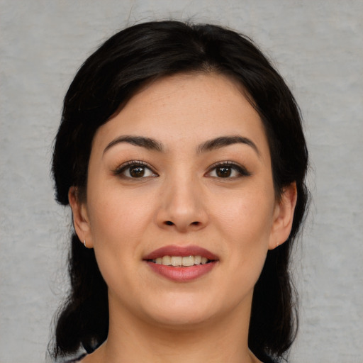 Joyful white young-adult female with medium  black hair and brown eyes