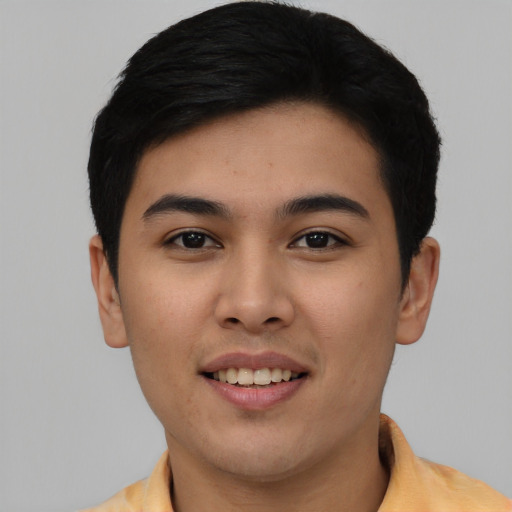 Joyful asian young-adult male with short  black hair and brown eyes