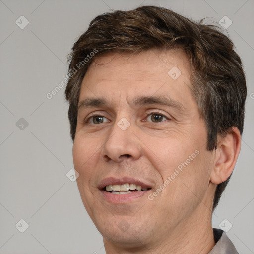 Joyful white adult male with short  brown hair and brown eyes