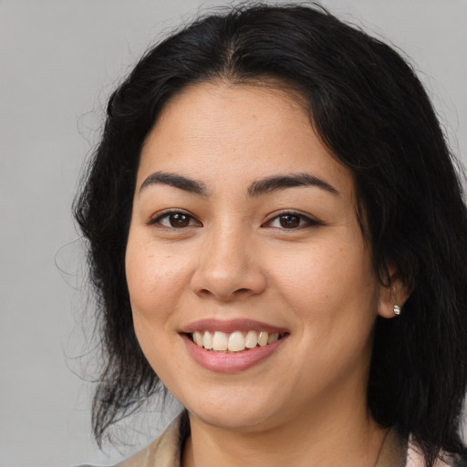 Joyful asian young-adult female with long  brown hair and brown eyes