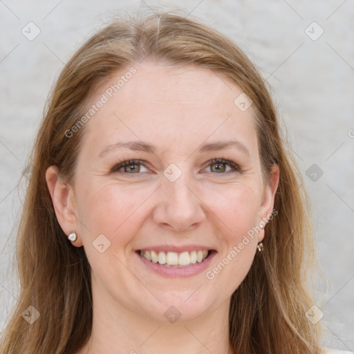 Joyful white adult female with long  brown hair and grey eyes