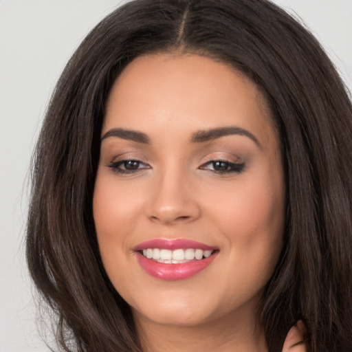 Joyful white young-adult female with long  brown hair and brown eyes