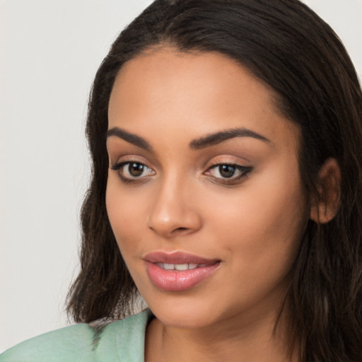 Joyful latino young-adult female with long  brown hair and brown eyes