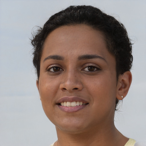 Joyful latino young-adult female with short  brown hair and brown eyes