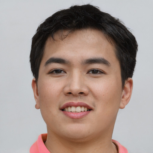 Joyful asian young-adult male with short  brown hair and brown eyes