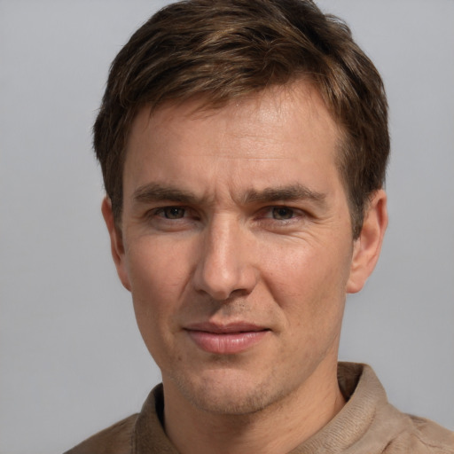 Joyful white adult male with short  brown hair and grey eyes