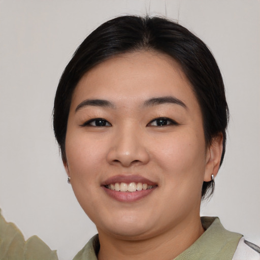 Joyful asian young-adult female with medium  black hair and brown eyes