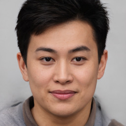 Joyful asian young-adult male with short  brown hair and brown eyes