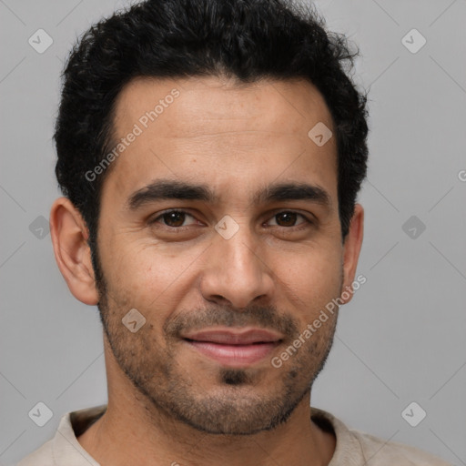 Joyful white young-adult male with short  black hair and brown eyes