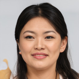 Joyful asian young-adult female with long  brown hair and brown eyes