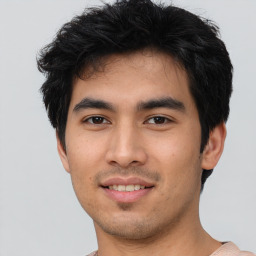 Joyful asian young-adult male with short  black hair and brown eyes