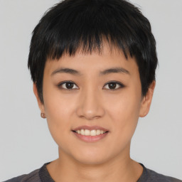 Joyful asian young-adult female with short  black hair and brown eyes