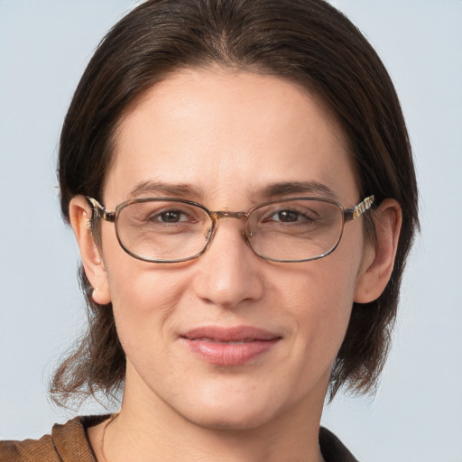 Joyful white adult female with medium  brown hair and grey eyes