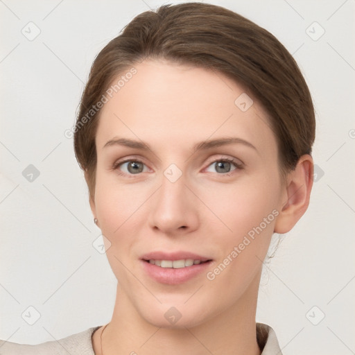 Joyful white young-adult female with short  brown hair and grey eyes