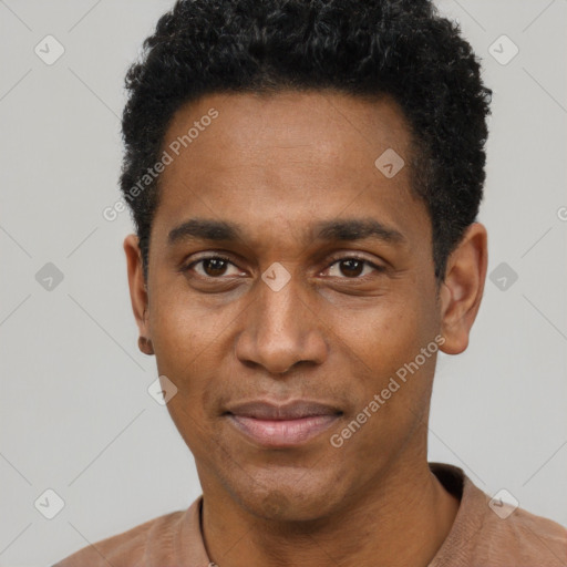 Joyful black young-adult male with short  black hair and brown eyes