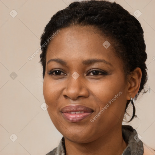 Joyful black young-adult female with long  brown hair and brown eyes