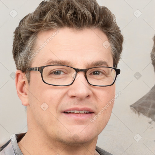 Joyful white adult male with short  brown hair and blue eyes