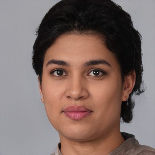 Joyful latino young-adult female with short  black hair and brown eyes