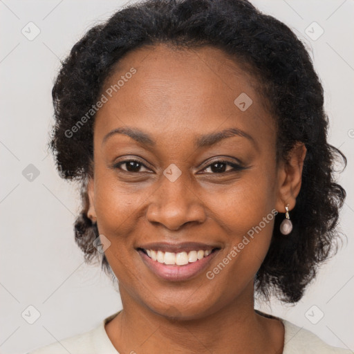 Joyful black adult female with short  brown hair and brown eyes