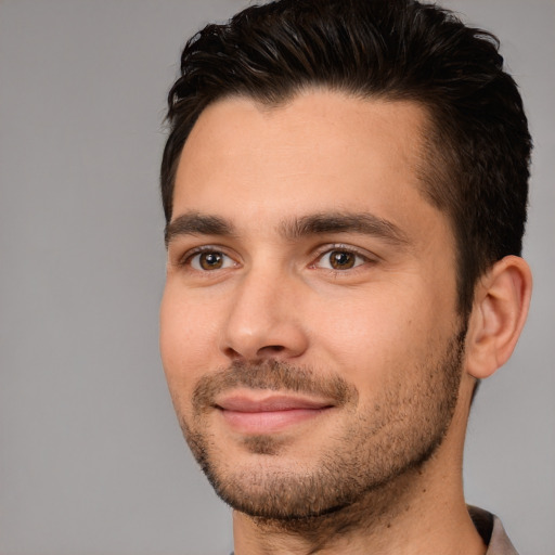 Joyful white young-adult male with short  brown hair and brown eyes