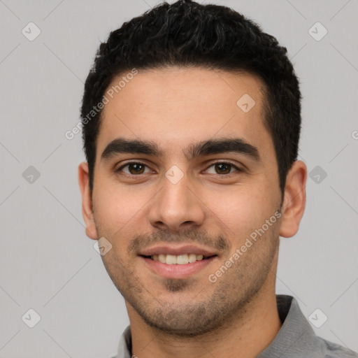 Joyful white young-adult male with short  black hair and brown eyes