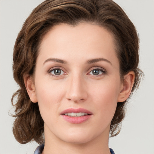 Joyful white young-adult female with medium  brown hair and green eyes