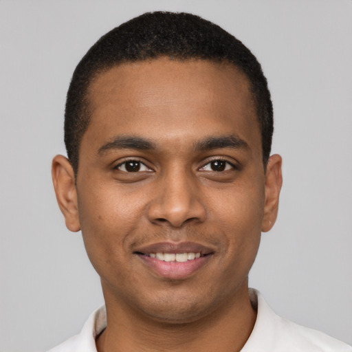 Joyful black young-adult male with short  brown hair and brown eyes