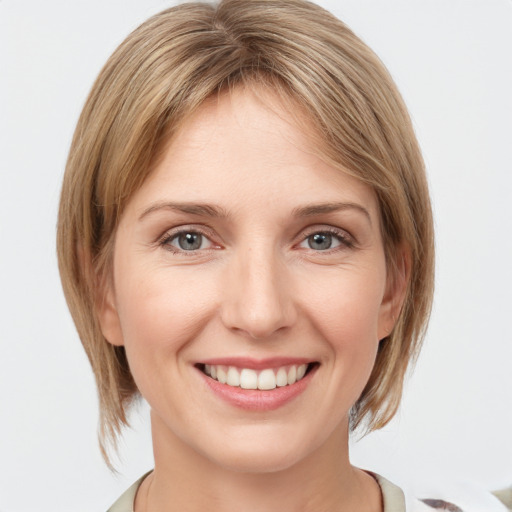 Joyful white young-adult female with medium  brown hair and grey eyes